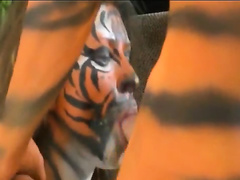 Babe painted as tiger sucks on cock