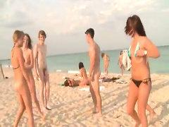 Sexy college girls play on the beach in bikinis